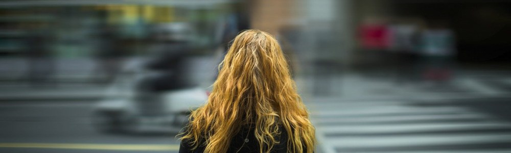 girl in the city crossing the street
