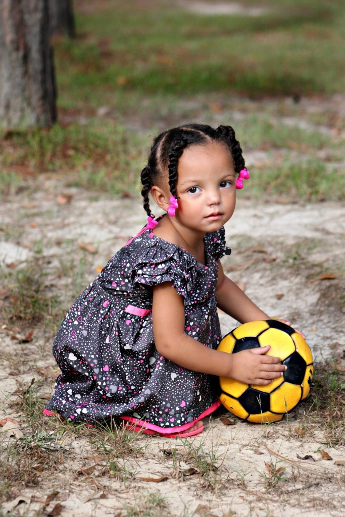 little girl with soccer ball
