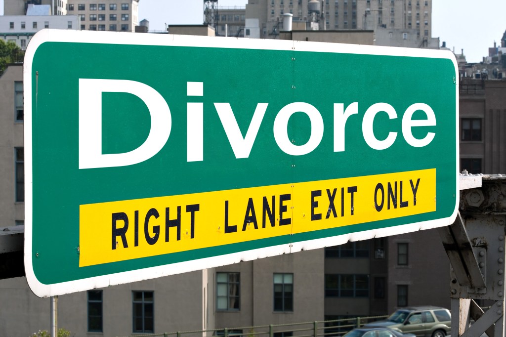A green highway sign with the word Divorce on it.